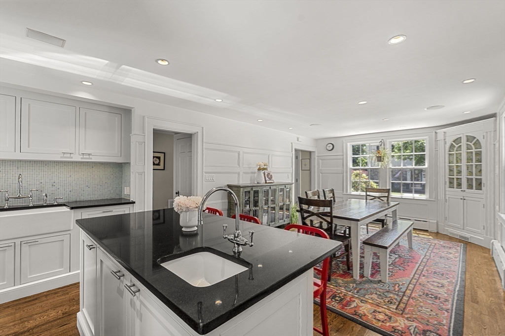 56 Allen Circle Milton, MA 02186 - Photo 10 of 34 a kitchen with stainless steel appliances granite countertop a sink a stove and a refrigerator with wooden floor