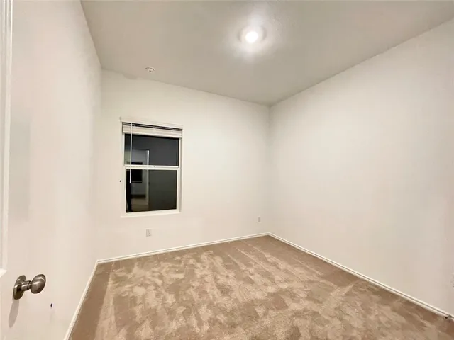 an empty room with a kitchen