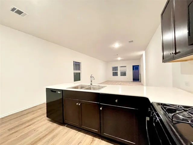 a kitchen with a sink and cabinets
