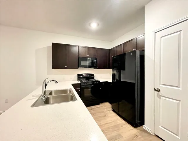 a kitchen with a refrigerator and a sink