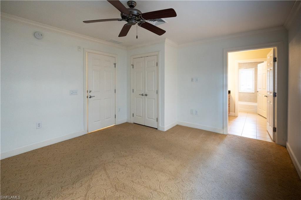 1362 Centre Ct Ridge Drive, Unit 101 Reunion, FL 34747 - Photo 11 of 25 Carpeted spare room featuring ornamental molding and ceiling fan