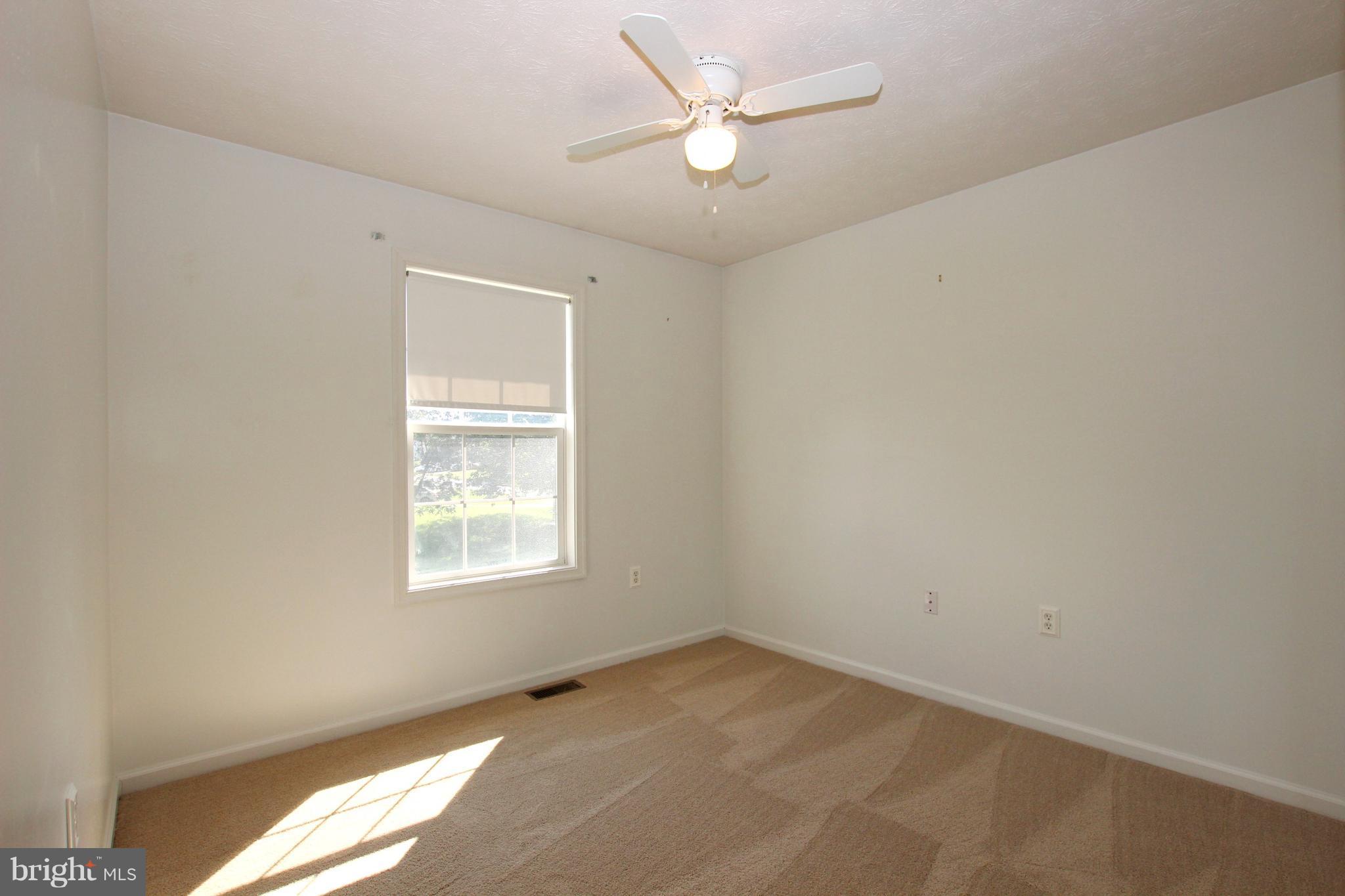 12 Cottontail Court Ranson, WV 25438 - Photo 13 of 29 an empty room with a window and a fan
