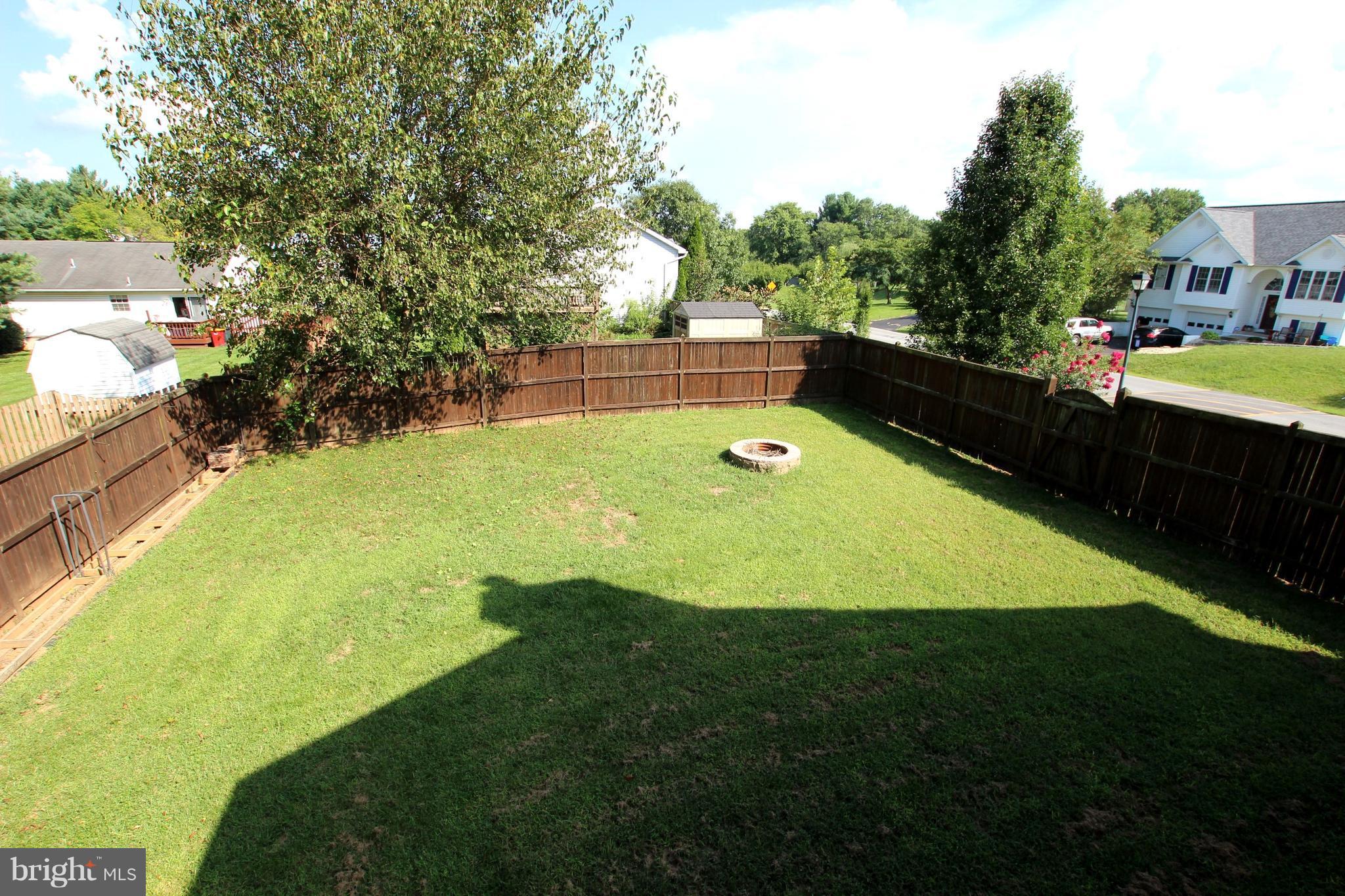 12 Cottontail Court Ranson, WV 25438 - Photo 26 of 29 a view of a swimming pool with a garden and trees