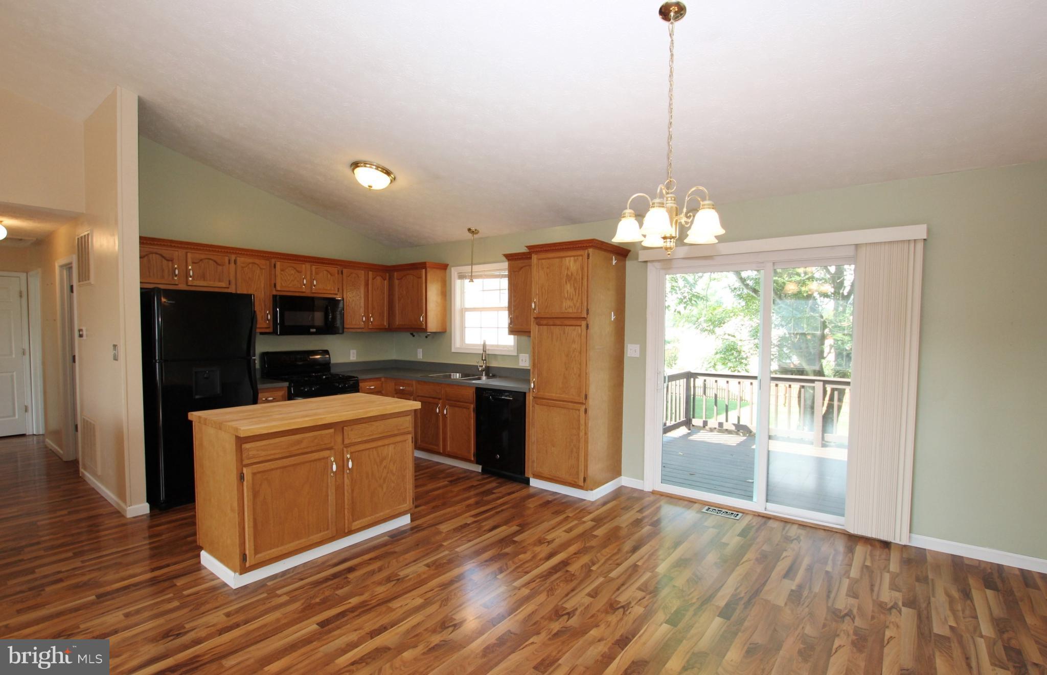 12 Cottontail Court Ranson, WV 25438 - Photo 8 of 29 a kitchen that has a refrigerator a stove top oven a counter space and wooden floor