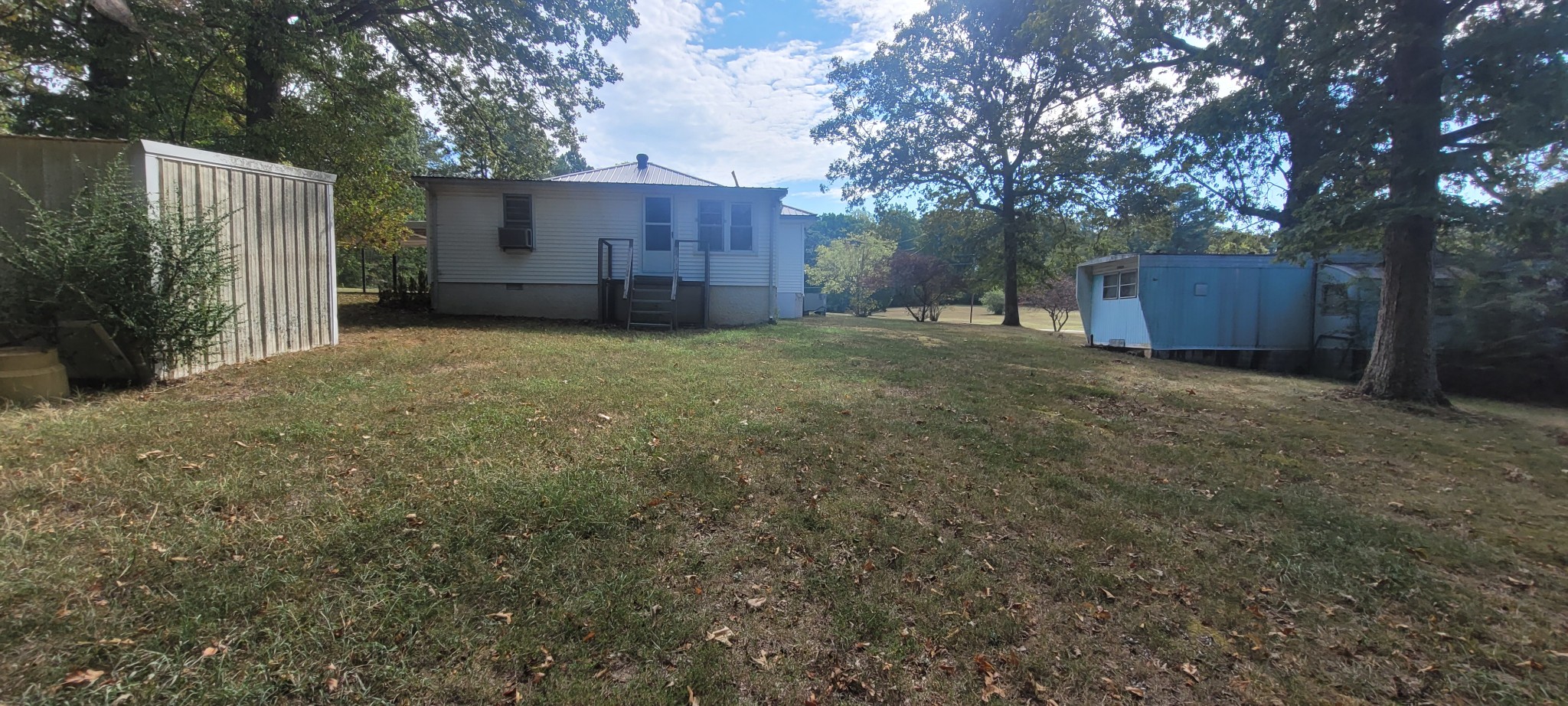 10183 New Hope Road Bon Aqua, TN 37025 - Photo 15 of 27 View of home backyard picture, old trailer is storage only, and thats a green house to left of yard