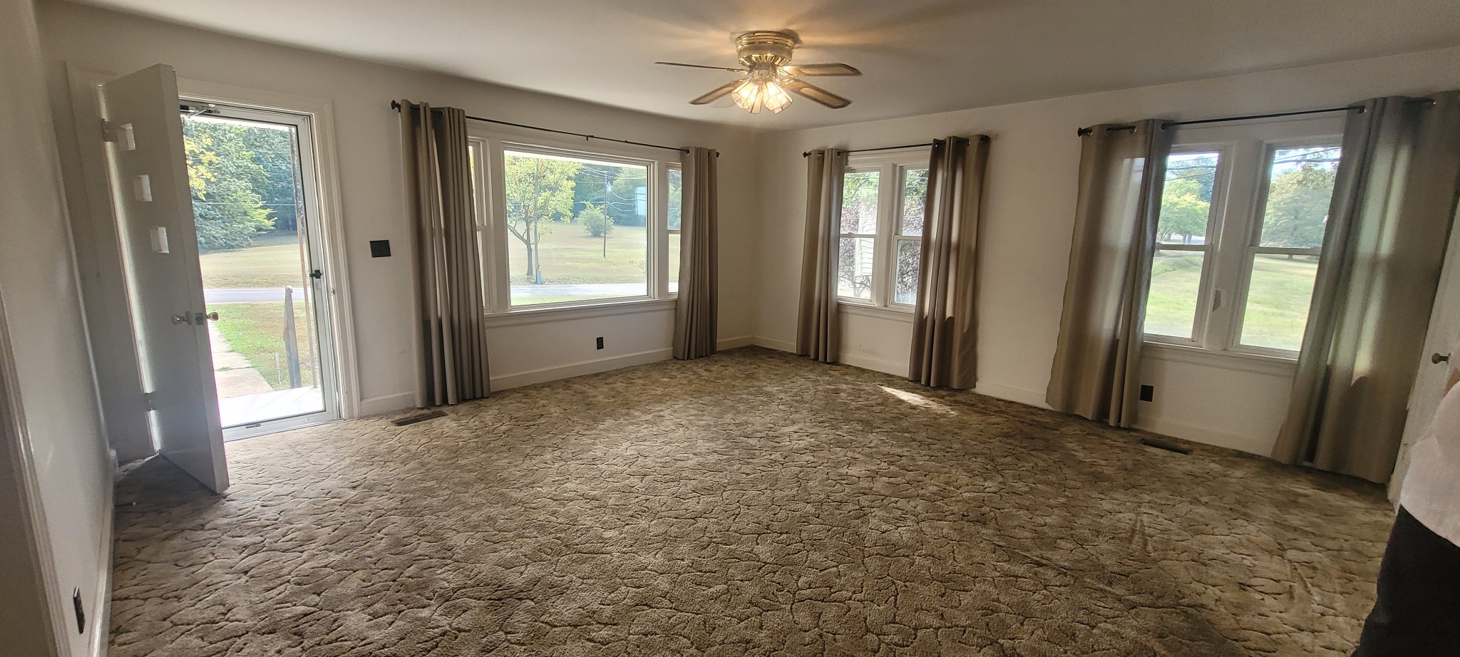 10183 New Hope Road Bon Aqua, TN 37025 - Photo 5 of 27 Large inviting living room space, lots of newer tilt in style windows, original hardwood floors under these carpets!