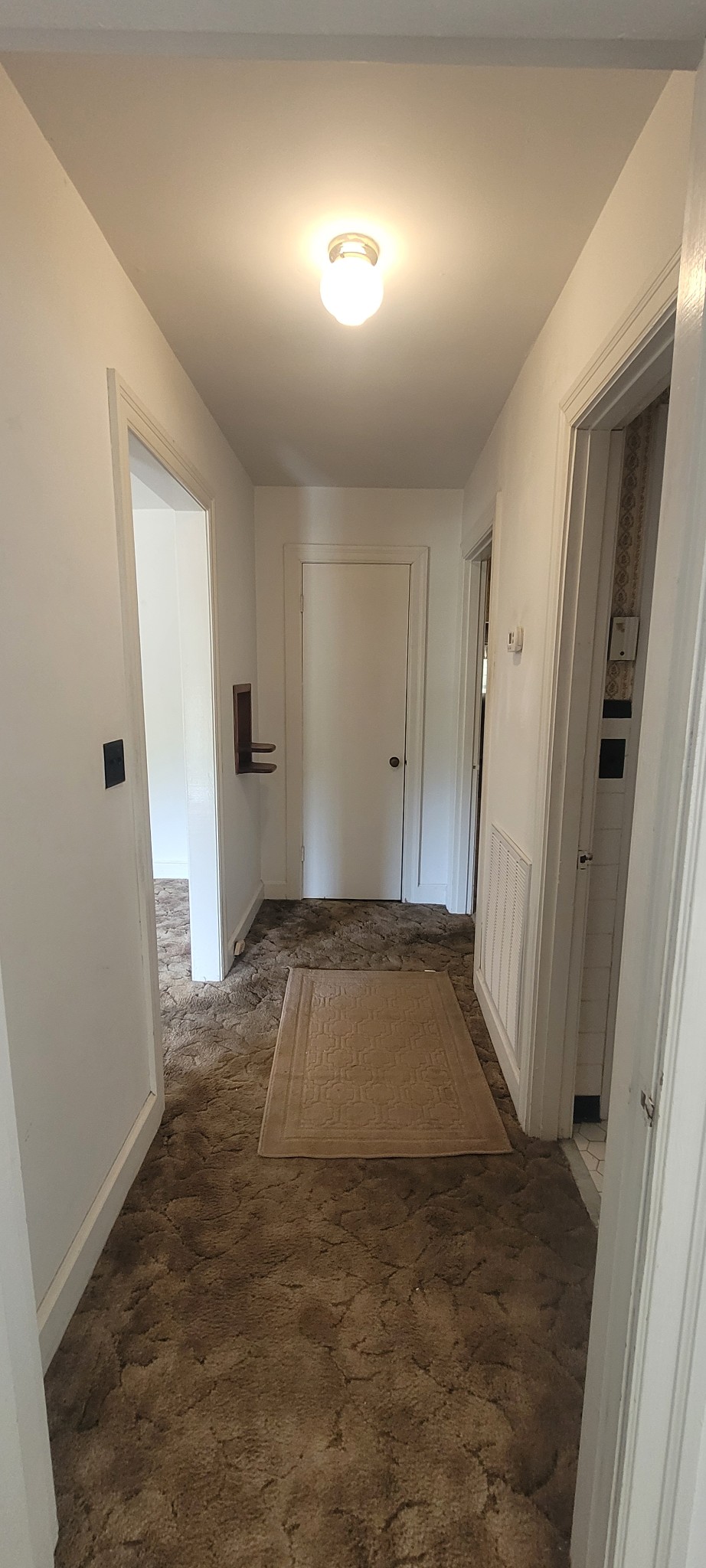 10183 New Hope Road Bon Aqua, TN 37025 - Photo 6 of 27 Hallway just off the living room, location of the bathroom and 2of the bedrooms, and cute built in antique phone table on wall left of picture