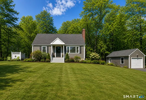 a front view of a house with a garden