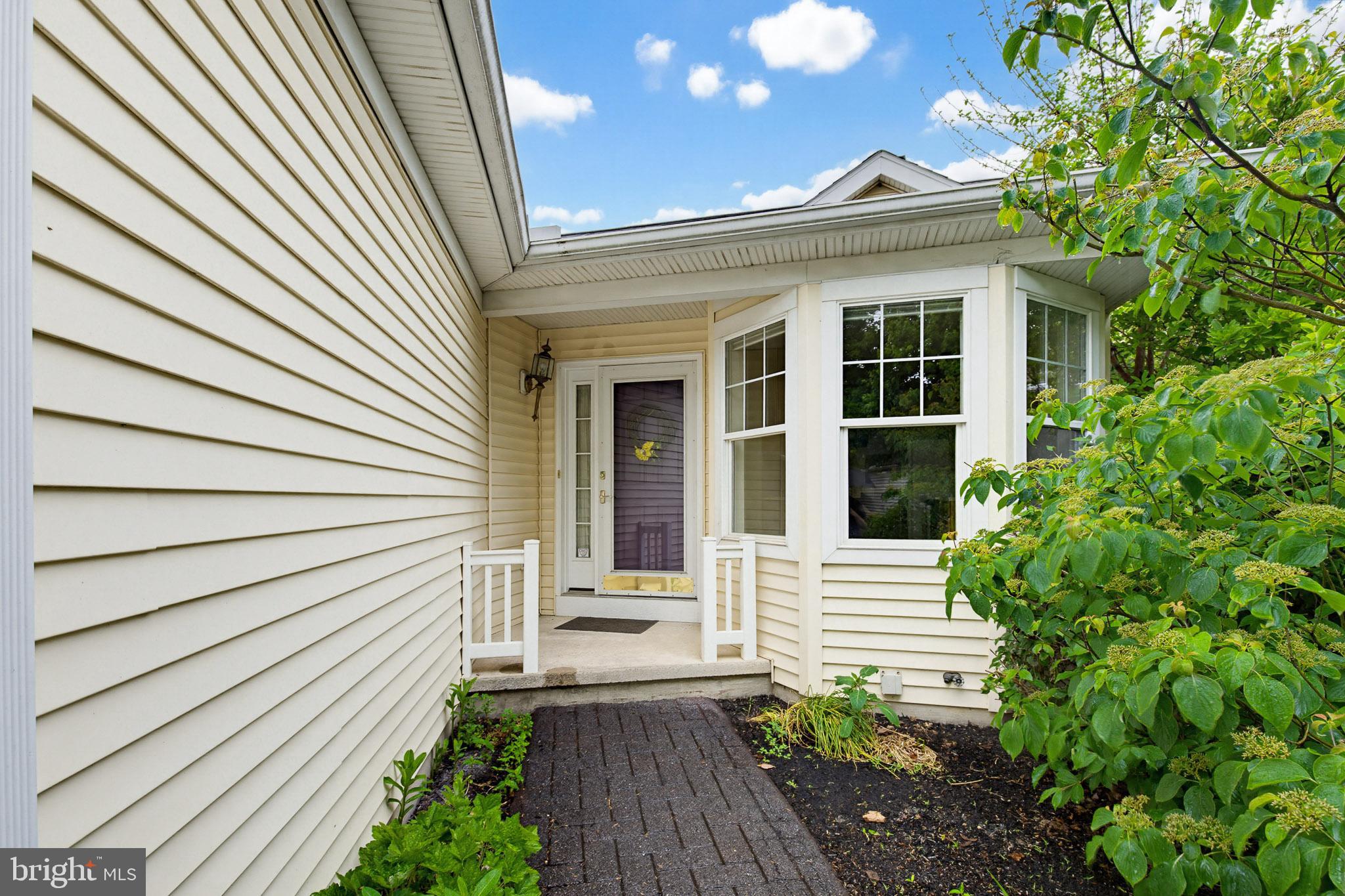 1037 Kent Garden Lititz, PA 17543 - Photo 3 of 31 a view of a house with a white door and wooden bench