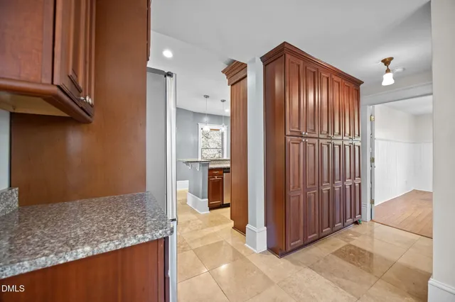 a large kitchen with stainless steel appliances granite countertop a stove a sink dishwasher and a refrigerator