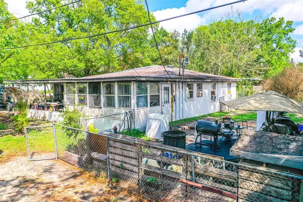 a view of a chair and tables in the back yard