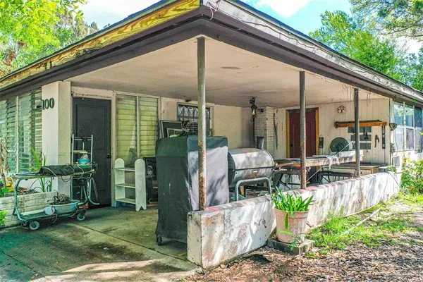 a backyard of a house with outdoor seating