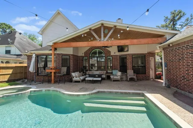 a view of a house with backyard space and sitting area