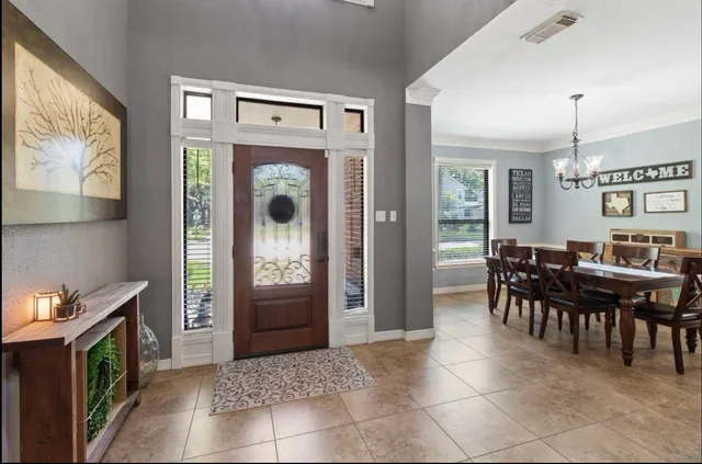 a view of a dining area with furniture and chandelier