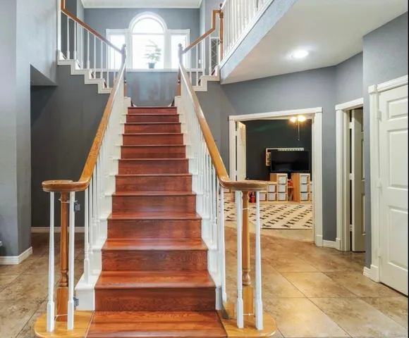 a living room with furniture fireplace and a large window