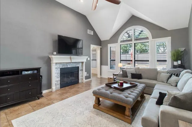 a dining room with furniture a chandelier and window