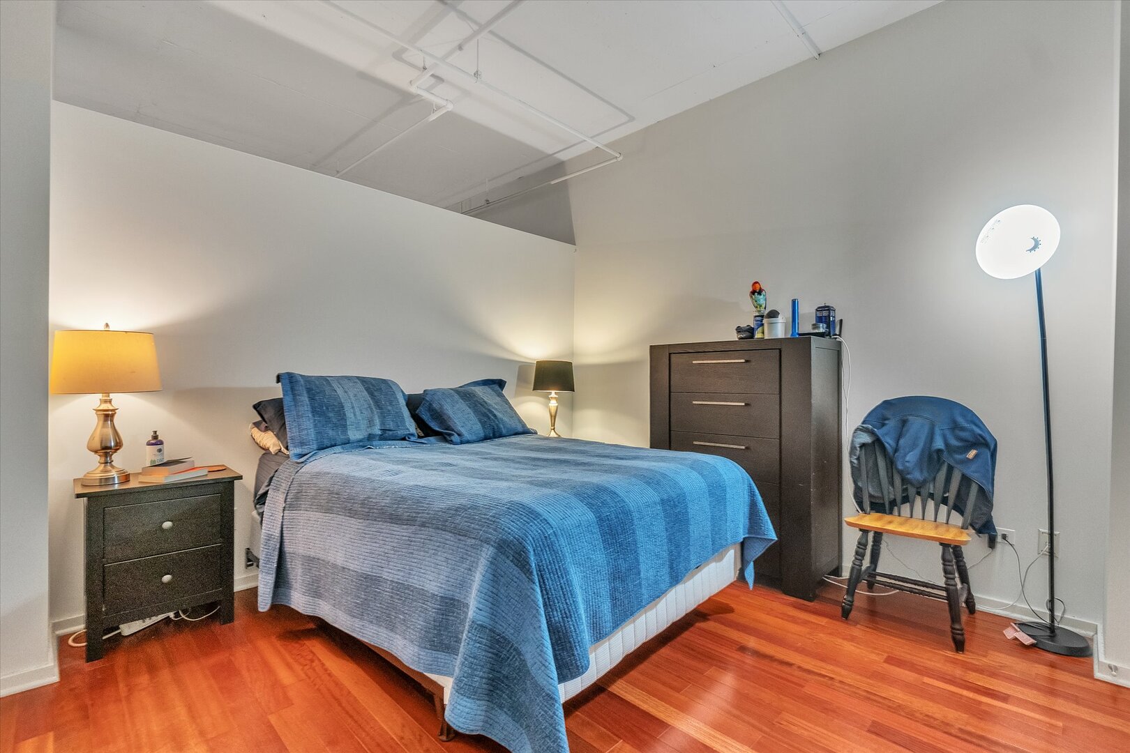 520 South State Street, Unit 805 Chicago, IL 60605 - Photo 11 of 24 a bedroom with a bed and wooden floor