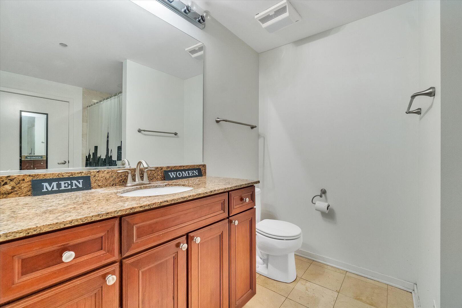 520 South State Street, Unit 805 Chicago, IL 60605 - Photo 13 of 24 a bathroom with a granite countertop sink a toilet and a mirror