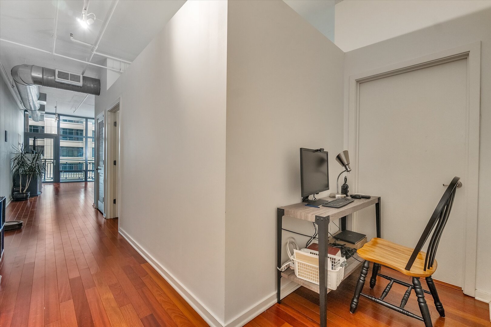 520 South State Street, Unit 805 Chicago, IL 60605 - Photo 7 of 24 a view of a workspace with furniture and wooden floor