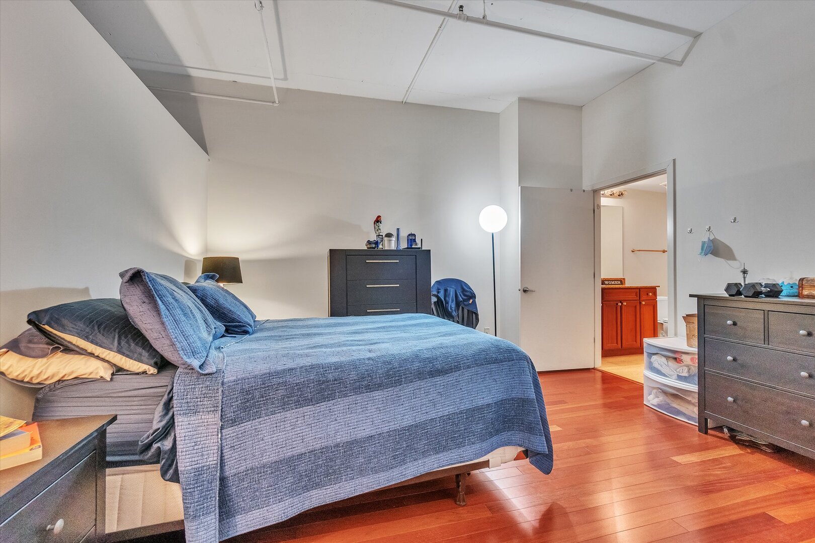 520 South State Street, Unit 805 Chicago, IL 60605 - Photo 9 of 24 a spacious bedroom with a bed and wooden floor