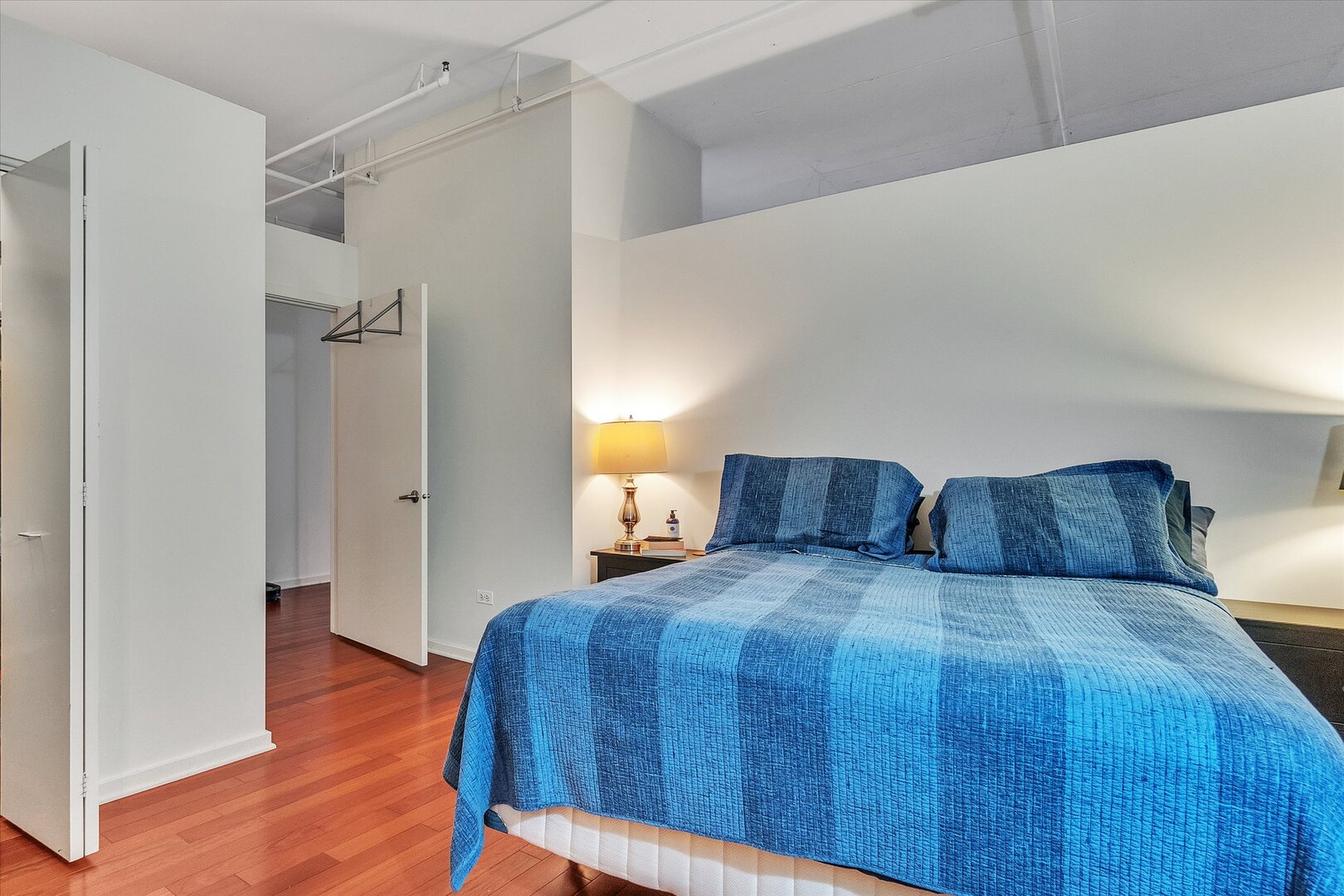 520 South State Street, Unit 805 Chicago, IL 60605 - Photo 10 of 24 a bedroom with a bed and wooden floor