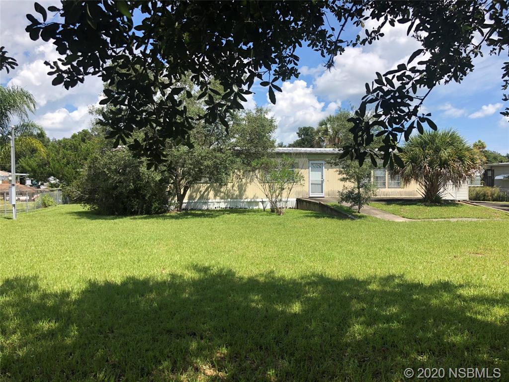 151 Charles Street Edgewater, FL 32141 - Photo 1 of 4 a view of a house with a big yard