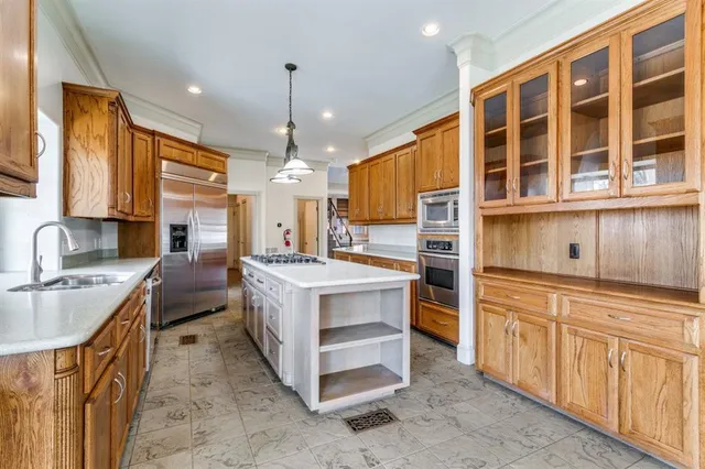 a kitchen that has a lot of cabinets and wooden floor