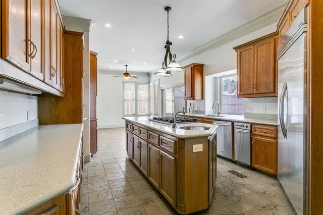 a kitchen with a stove top oven sink and refrigerator
