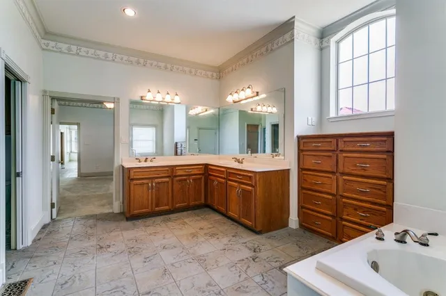 a large bathroom with a sink a washer and dryer