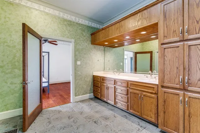 a view of a bathroom with mirror and sink