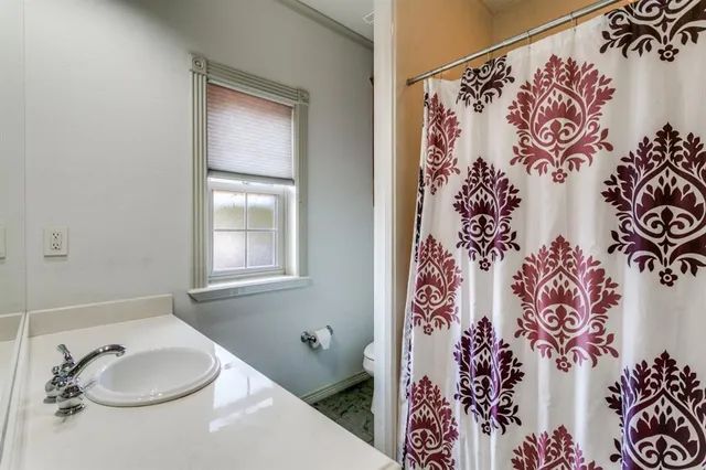 a bathroom with a shower and a sink