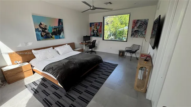 a bedroom with furniture and a window