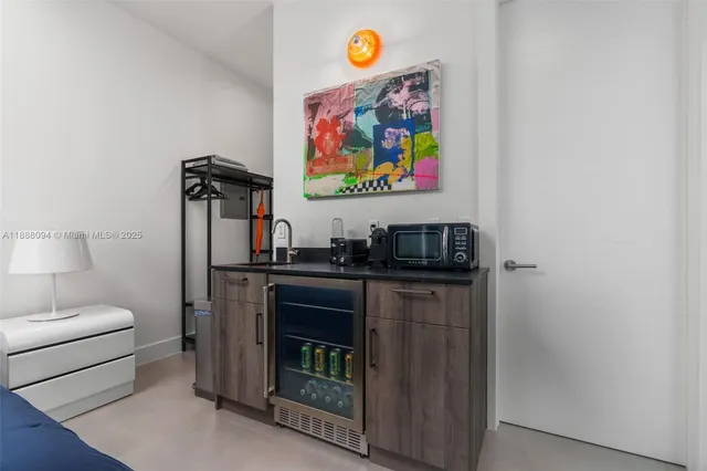 a living room with stainless steel appliances granite countertop furniture and a fireplace