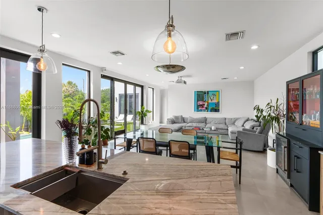 a living room with lots of furniture and a potted plant