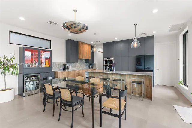 a kitchen with a table and chairs in it