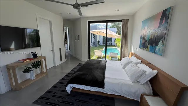 a bedroom with a bed and a television