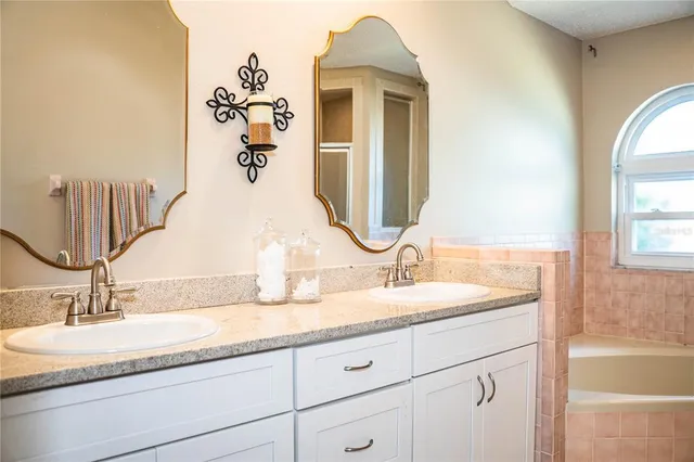 a bathroom with a double vanity sink and a mirror