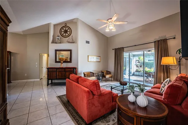a living room with furniture a chandelier and a large window