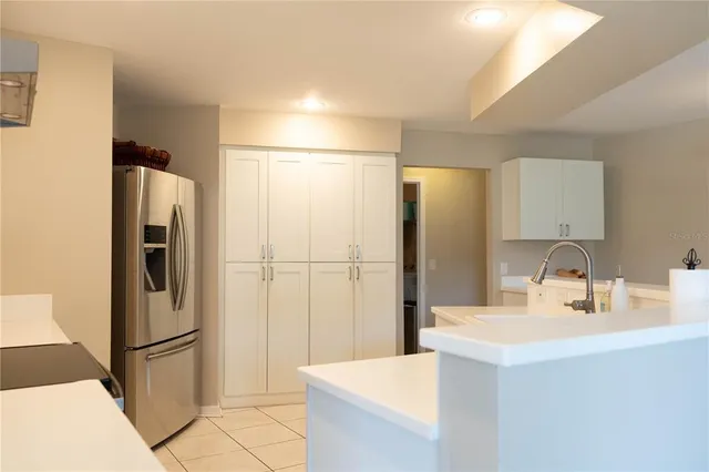 a kitchen with a refrigerator and a sink