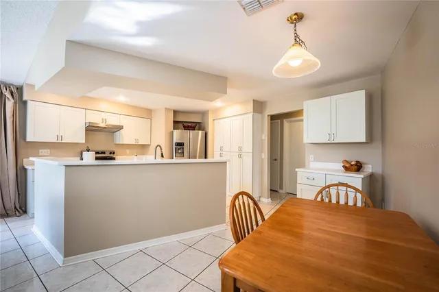 a view of a kitchen and dining room with wooden floor