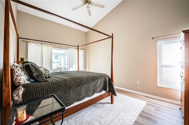 a bed sitting in a bedroom next to a window