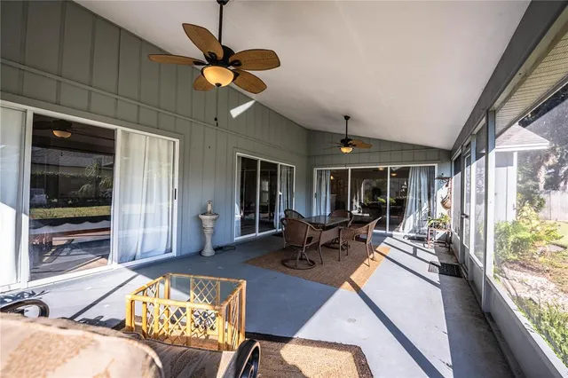 a living room with furniture and large windows