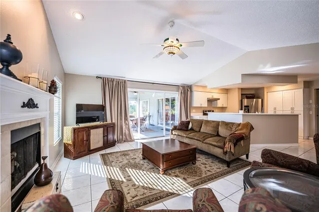 a living room with furniture a fireplace and a flat screen tv