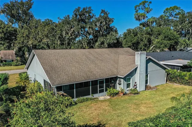 an aerial view of a house with a yard