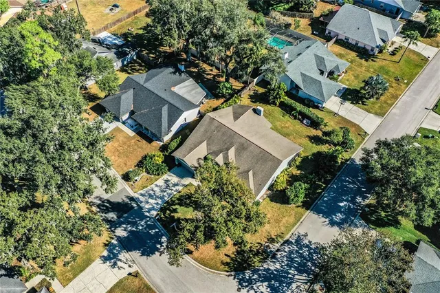 an aerial view of a house with a yard