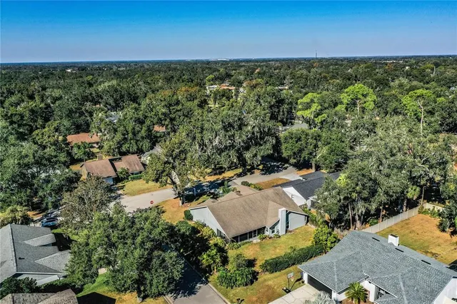 an aerial view of a house with a yard