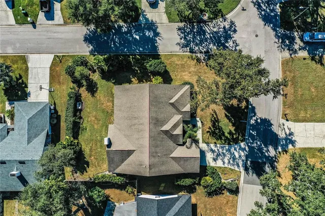 an aerial view of a house with a yard basket ball court and outdoor seating