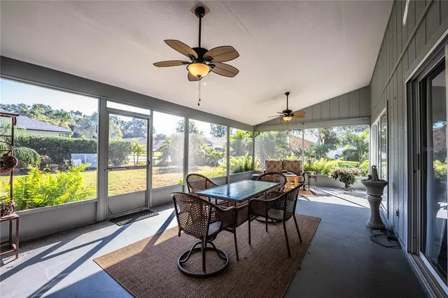 a dining room with furniture a chandelier and wooden floor