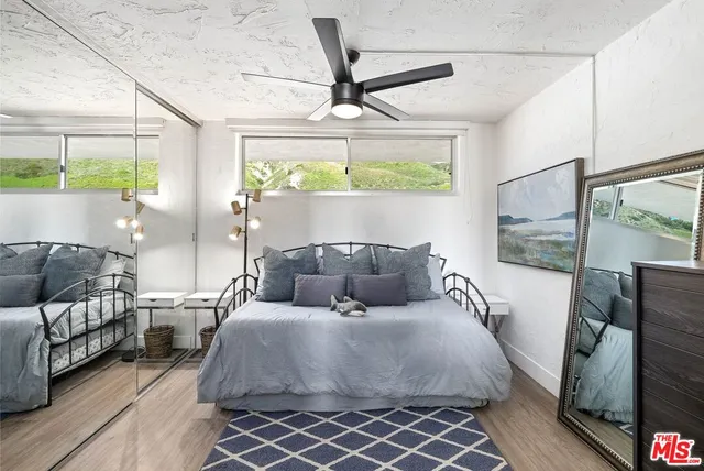 a kitchen with stainless steel appliances granite countertop a refrigerator a sink dishwasher a stove and a refrigerator with wooden floor