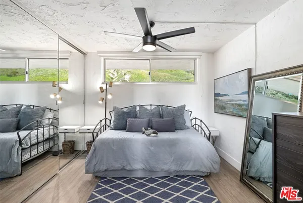 a kitchen with stainless steel appliances granite countertop a refrigerator a sink dishwasher a stove and a refrigerator with wooden floor